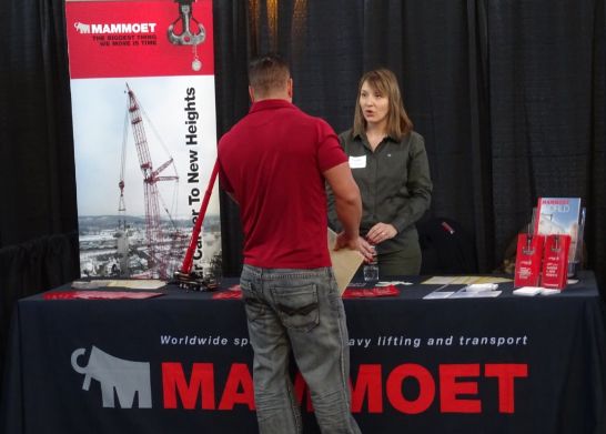 a man in a red shirt check out Mammoet booth